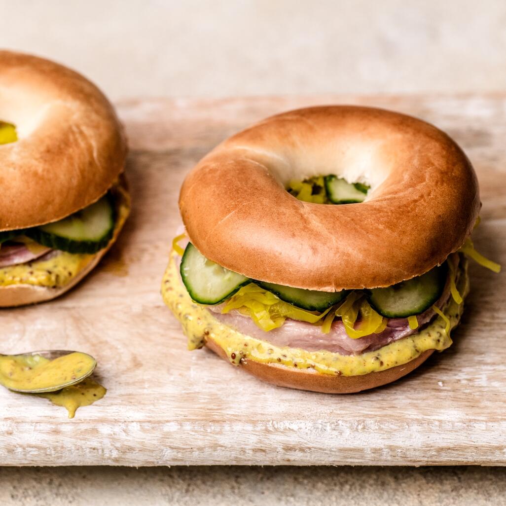 cooked beef bagel on wooden tray 