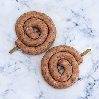 The Cumberland Swirl Sausage on Marble Background