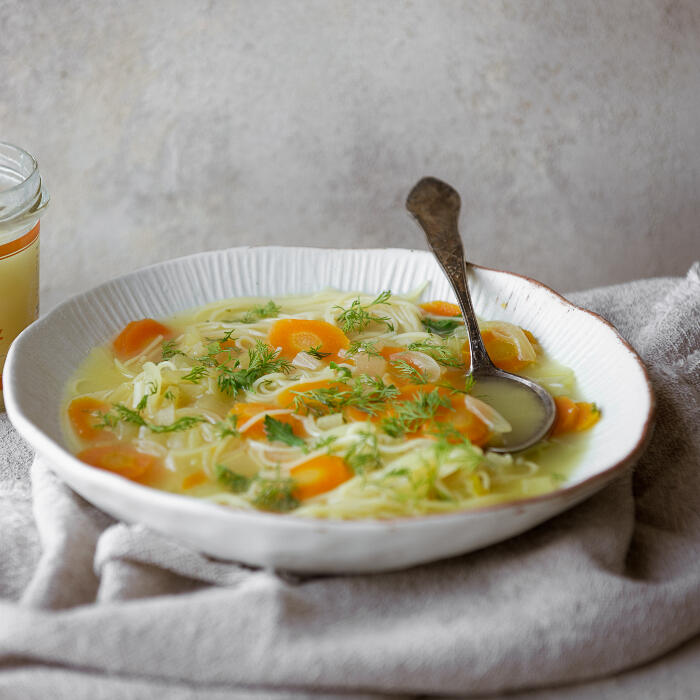 chicken noodle soup with veggies in bowl