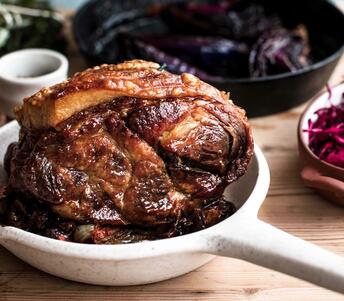 roasted pork shoulder with roasted red cabbage and green sauce