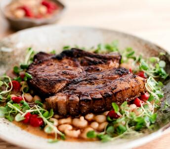 pork chops cooked in chilli butter with white beans