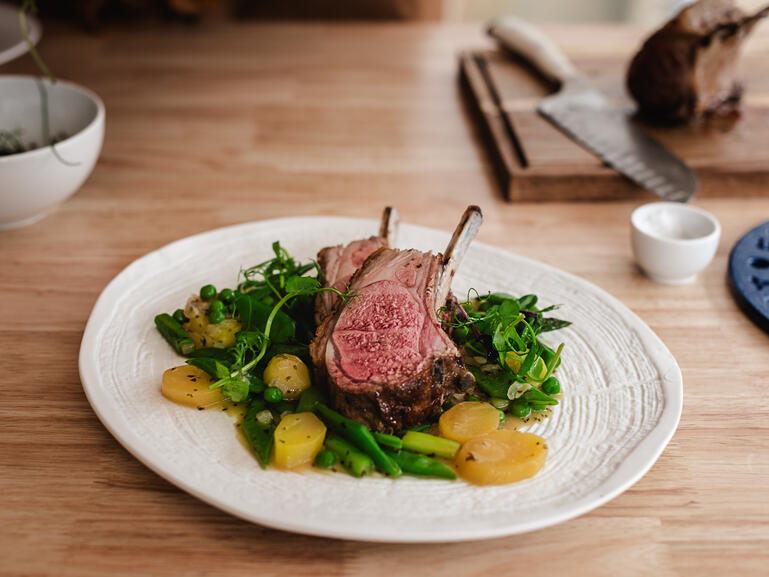 rack of lamb with vegetables and garlic with butter cooked 