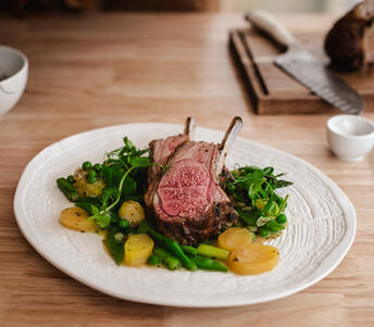 rack of lamb with vegetables and garlic with butter cooked 