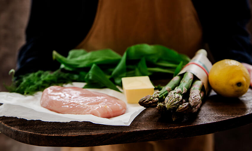 raw ingredients to prepare buttered chicken with asparagus and wild garlic