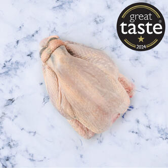 picture of a whole chicken raw on marble background 