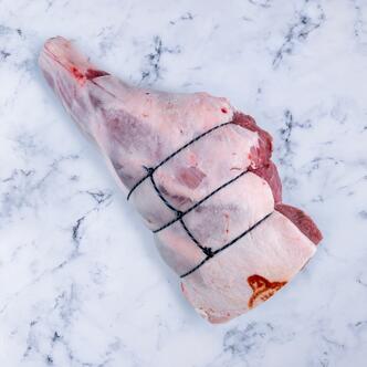 whole leg of lamb on marble background