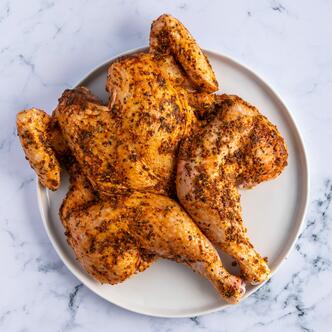 fennel & lemon spiced spatchcock chicken in marble background