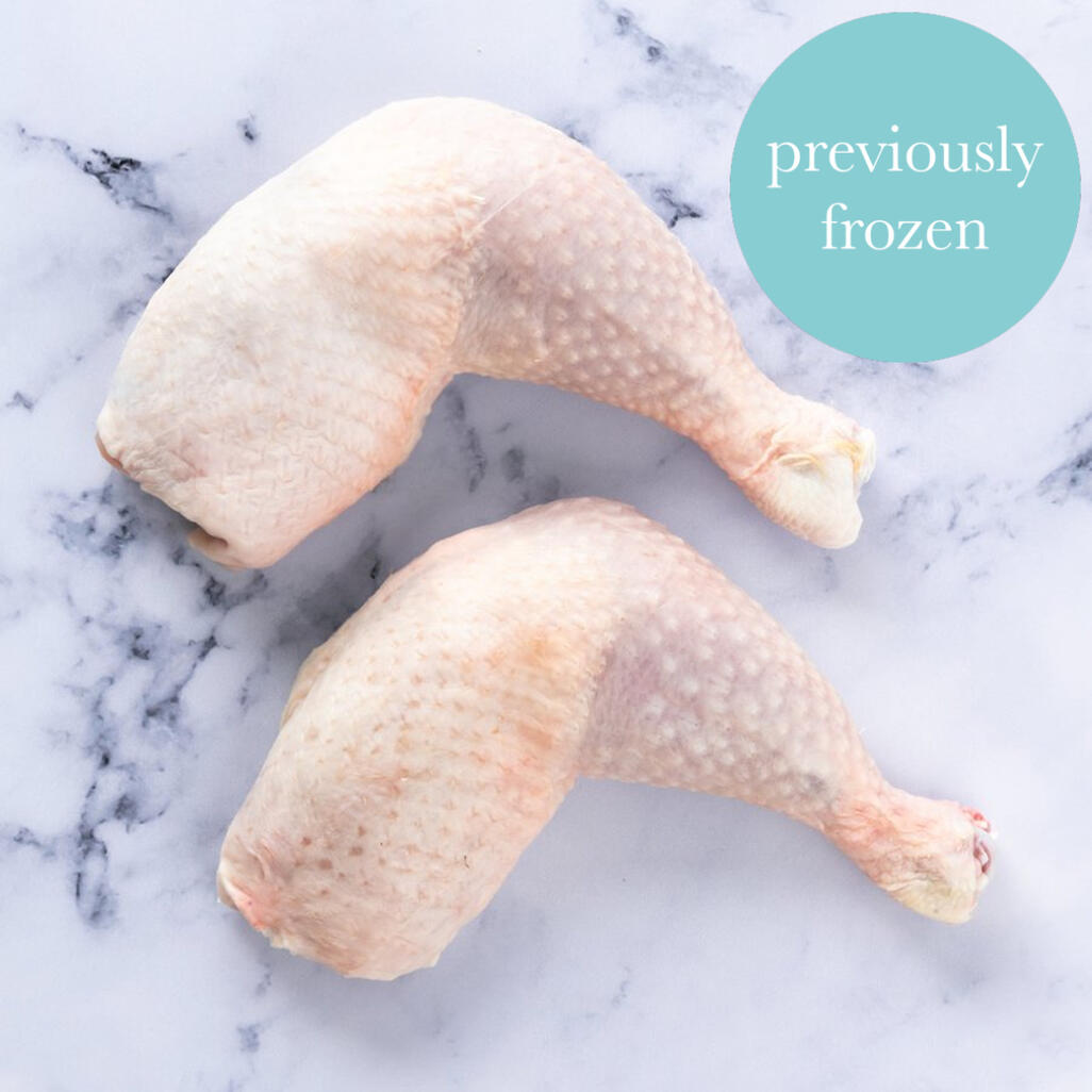 frozen chicken legs on marble background 