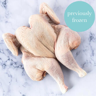 spatchcock chicken frozen on marble