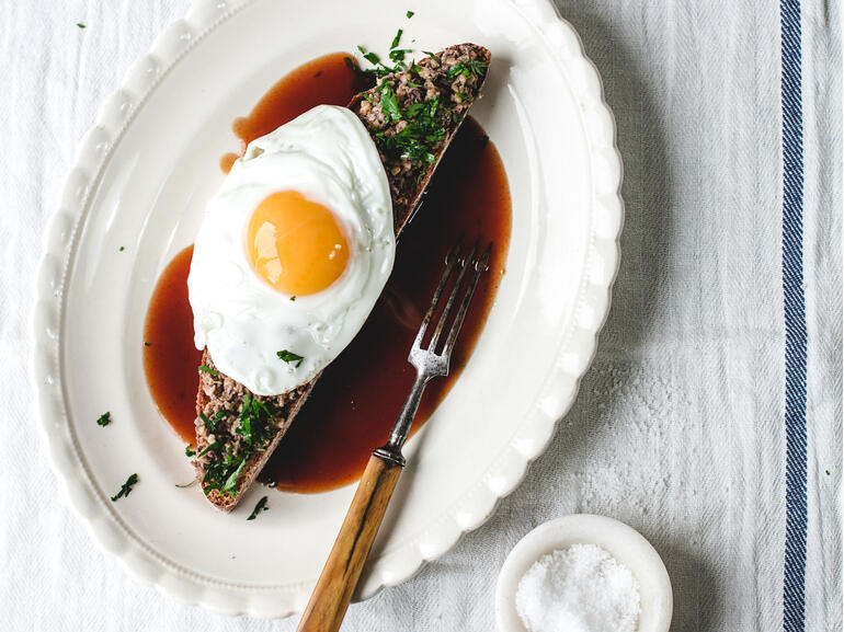 cooked haggis on toast with brown sauce and fried egg