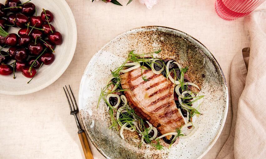 grilled pork chop with sweet pickled cherries