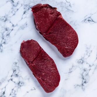 venison haunch steak on marble background