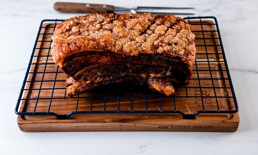 cooked pork belly on resting board