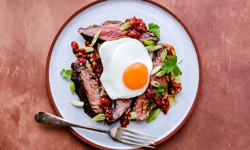 cooked steak and eggs with red pepper salsa