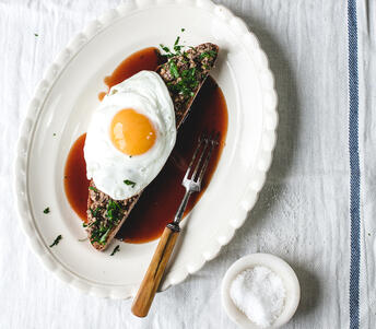 cooked haggis on toast with brown sauce and fried egg