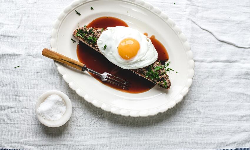 cooked haggis on toast with brown sauce and fried egg