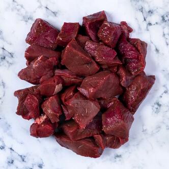 diced venison on marble background