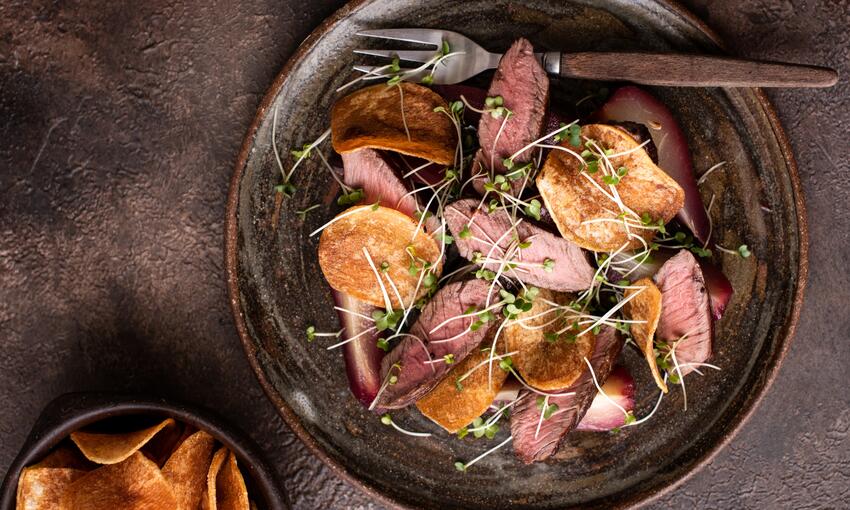 wild venison haunch steak with poached pears in red wine cooked