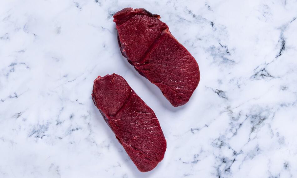 raw venison meat on marble 