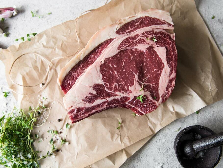 beef roasting joint lay flat on a parchment paper to show the extraordinary marbling