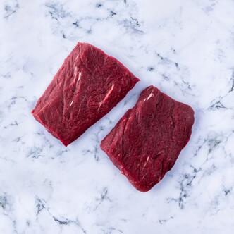 flat iron steak on marble background