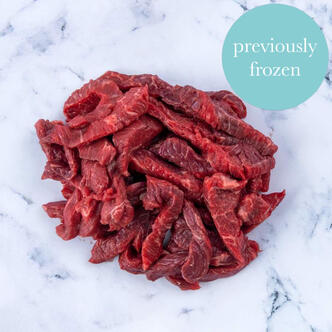 frozen pork steak strips on marble background 