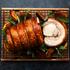 cooked porchetta on wood board