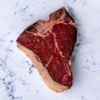 thick cut T bone on marble background 