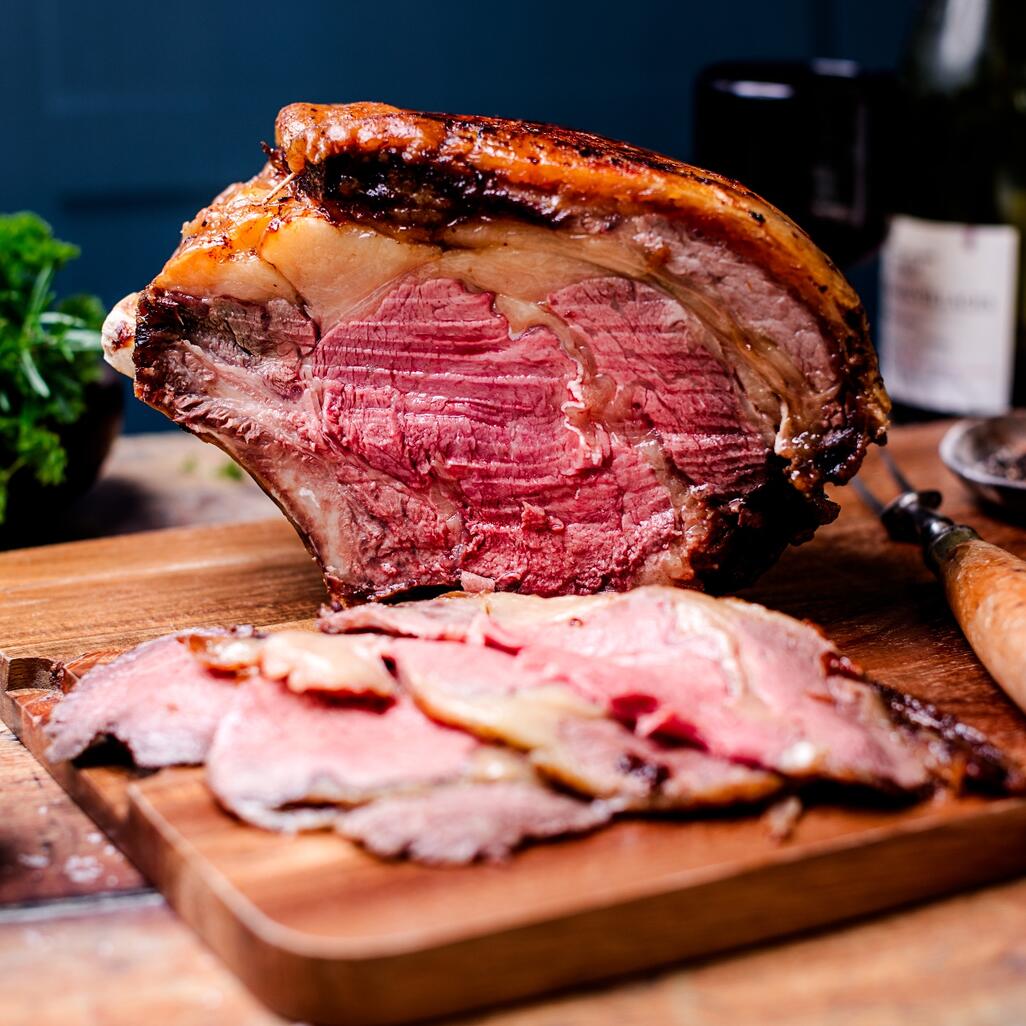 beef forerib cooked and sliced on wooden board 