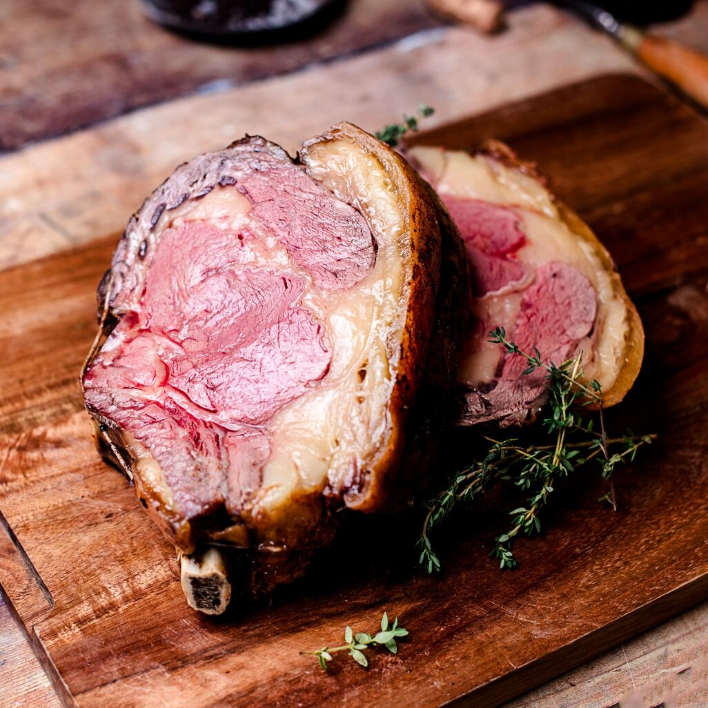 cooked beef forerib on wooden board 